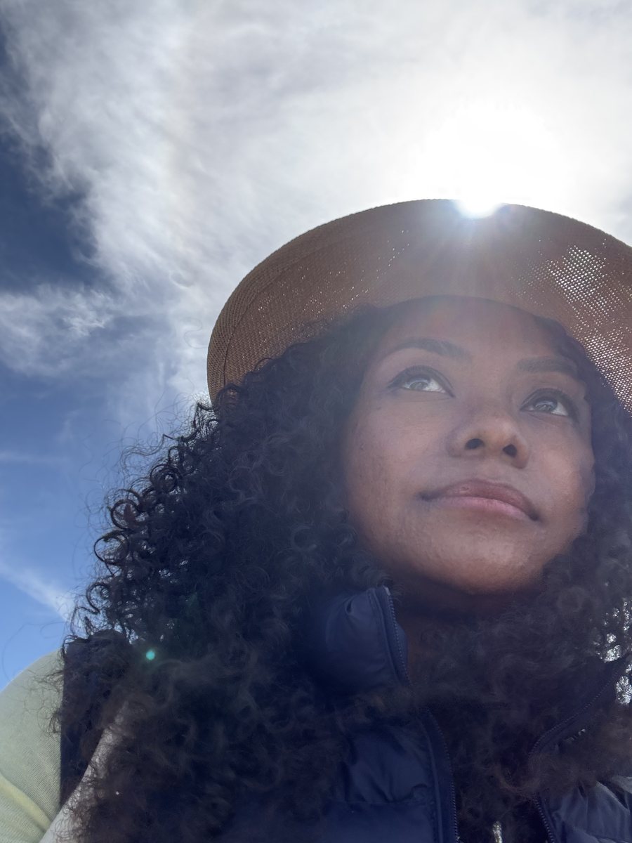 Faith Lantz, craniosacral therapist in Hong Kong, outdoors in a sun hat